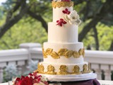 Gold and Purple Wedding Cake with Floral Accents 